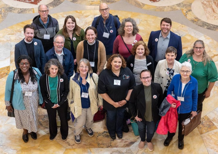Alt text: Peter Beeson with Badger State Housing Alliance advocates in the Wisconsin State Capitol rotunda, standing together for affordable housing and community flourishing.