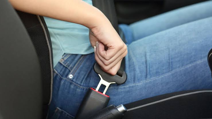 Image of a kid buckling up in a car, Just like Peter can make complex things (like child safety seats) simple for his kids, Realize makes the complicated process of real estate development and placemaking simple for congregations.